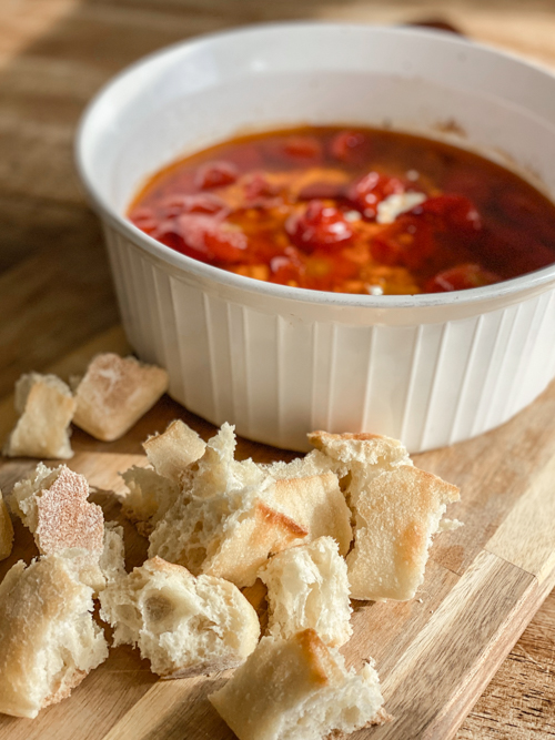 Enjoy summer's bounty with this Cherry Tomato and Burrata Appetizer Dip! Fresh tomatoes, creamy burrata, and crusty bread make the perfect tailgate or party dish.