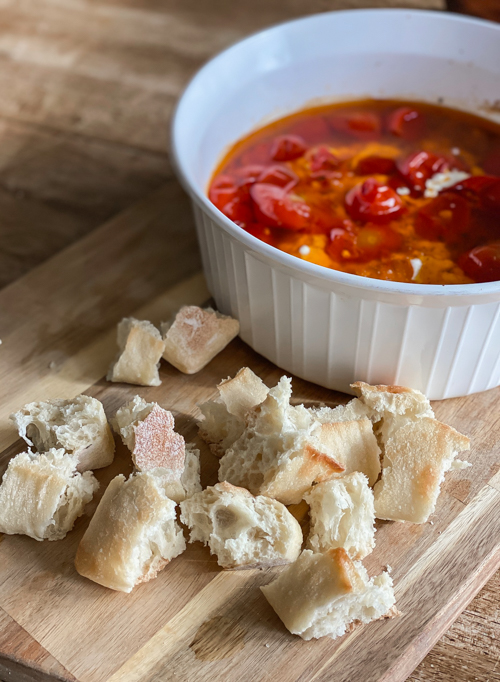 Enjoy summer's bounty with this Cherry Tomato and Burrata Appetizer Dip! Fresh tomatoes, creamy burrata, and crusty bread make the perfect tailgate or party dish.