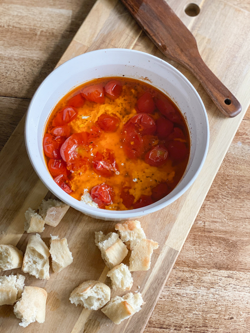 Enjoy summer's bounty with this Cherry Tomato and Burrata Appetizer Dip! Fresh tomatoes, creamy burrata, and crusty bread make the perfect tailgate or party dish.