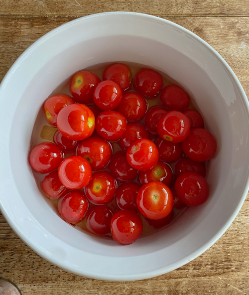 Enjoy summer's bounty with this Cherry Tomato and Burrata Appetizer Dip! Fresh tomatoes, creamy burrata, and crusty bread make the perfect tailgate or party dish.