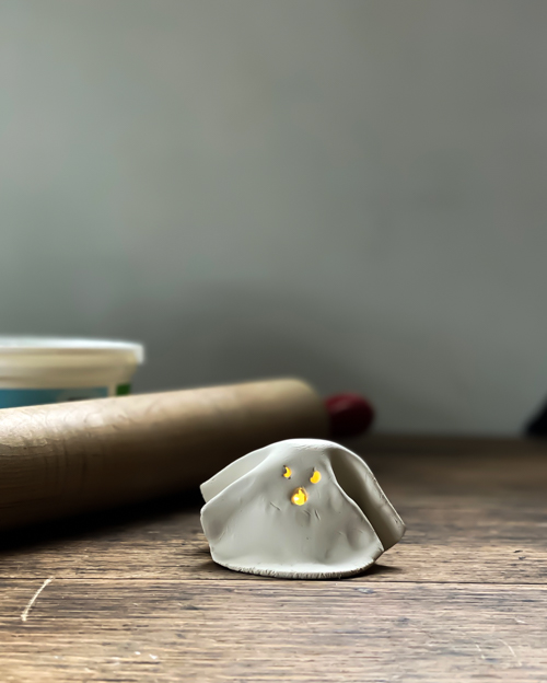 Create adorable DIY Clay Tea Light Ghosts for Halloween! Easy-to-make, spooky decor that glows with battery-operated lights. Perfect handmade charm for home!