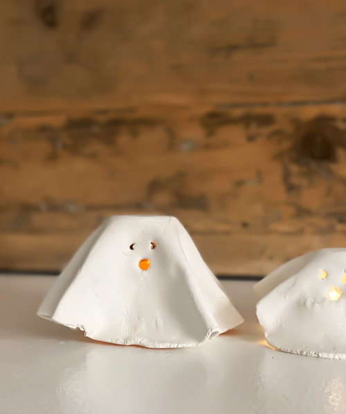 Create adorable DIY Clay Tea Light Ghosts for Halloween! Easy-to-make, spooky decor that glows with battery-operated lights. Perfect handmade charm for home!