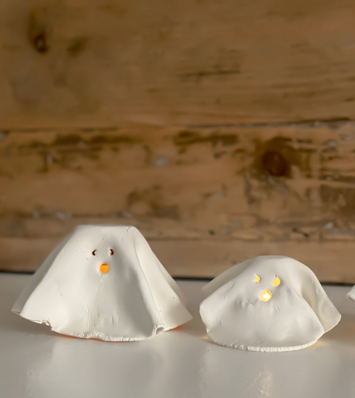 Create adorable DIY Clay Tea Light Ghosts for Halloween! Easy-to-make, spooky decor that glows with battery-operated lights. Perfect handmade charm for home!