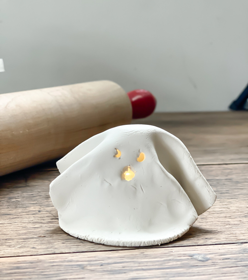 Create adorable DIY Clay Tea Light Ghosts for Halloween! Easy-to-make, spooky decor that glows with battery-operated lights. Perfect handmade charm for home!