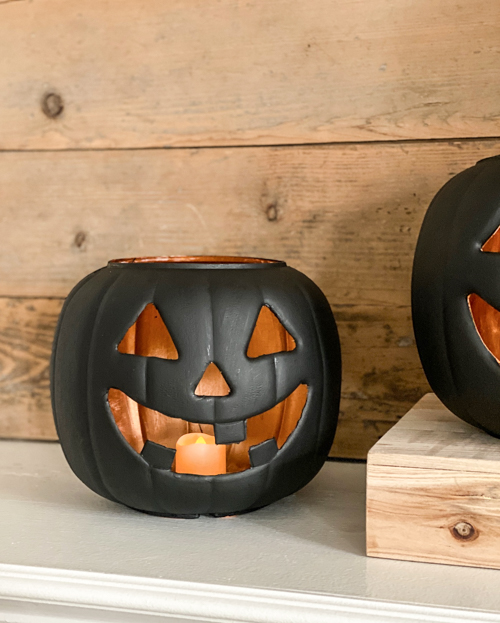 Create stylish Halloween decor with DIY Pottery Barn Jack-O-Lantern dupe. Get the high-end look for less than $5 using plastic pails, paint, and LED candles.