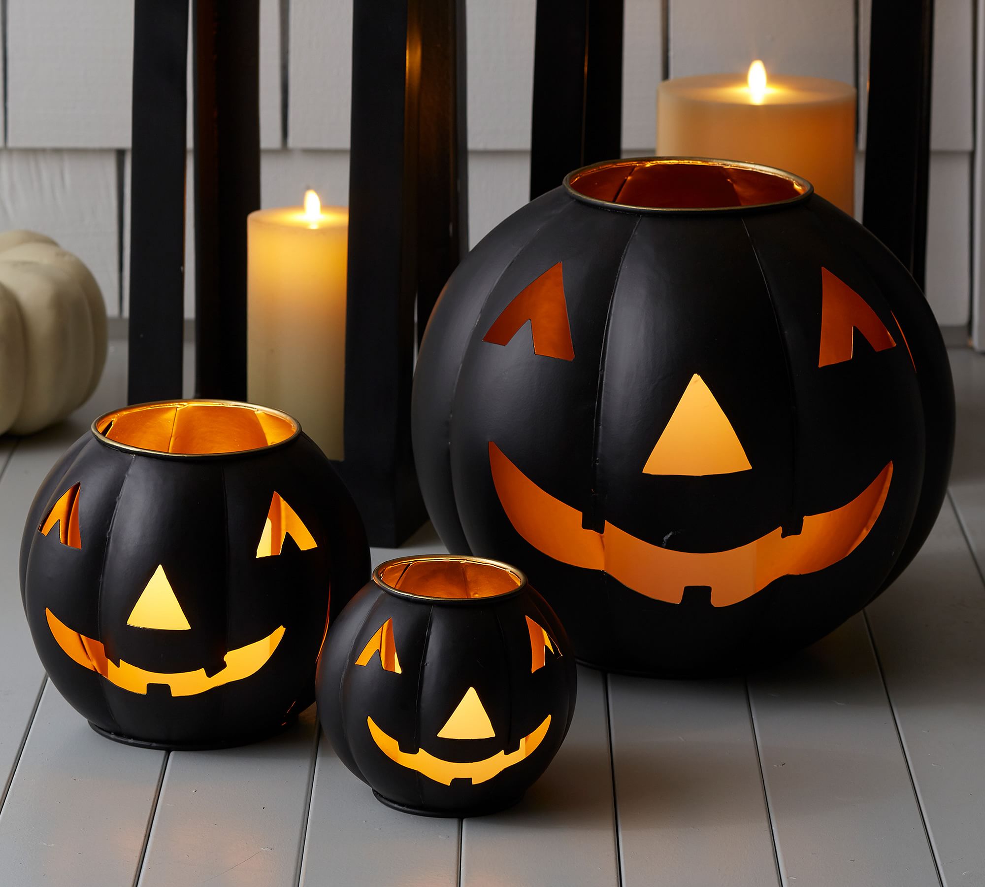 Create stylish Halloween decor with DIY Pottery Barn Jack-O-Lantern dupe. Get the high-end look for less than $5 using plastic pails, paint, and LED candles.