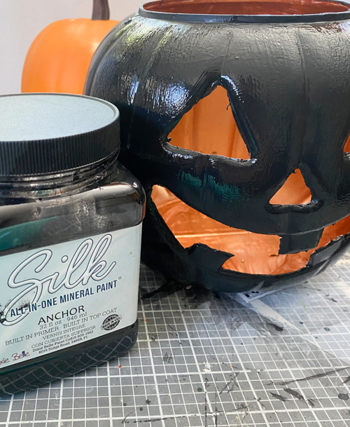 Create stylish Halloween decor with DIY Pottery Barn Jack-O-Lantern dupe. Get the high-end look for less than $5 using plastic pails, paint, and LED candles.