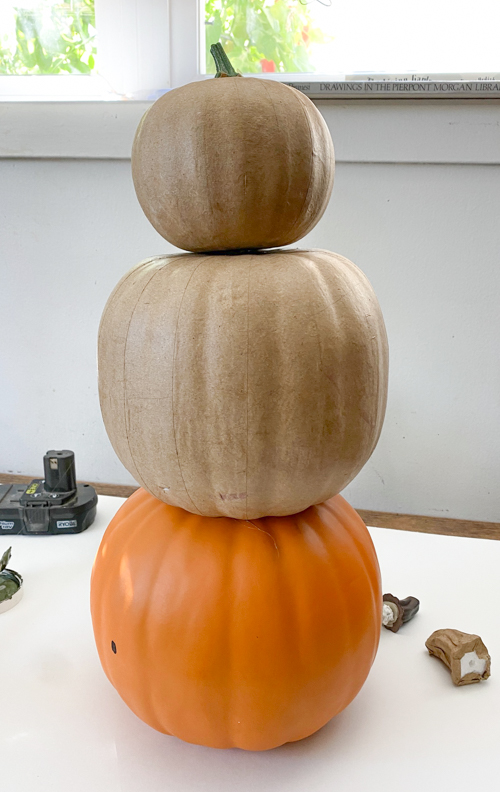 Learn how to make a DIY Pumpkin Topiary with paper mache and foam pumpkins, paint, and hot glue. This easy tutorial will add a festive touch to your fall decor!