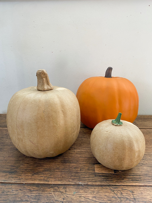 Learn how to make a DIY Pumpkin Topiary with paper mache and foam pumpkins, paint, and hot glue. This easy tutorial will add a festive touch to your fall decor!