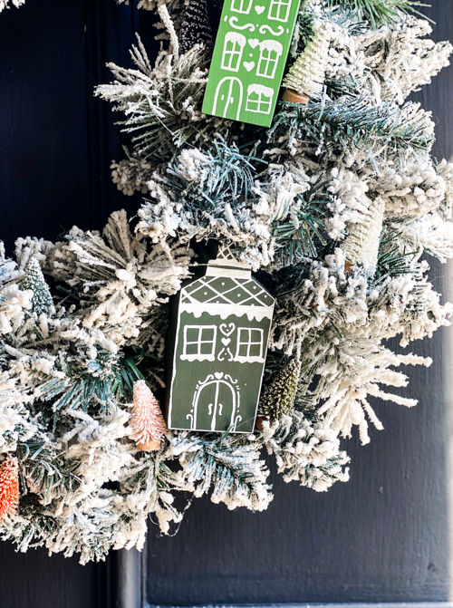 Create a festive DIY Christmas village wreath with thrifted items! This budget-friendly project adds a charming, personalized touch to your holiday decor.