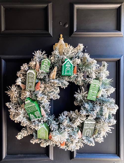 Create a festive DIY Christmas village wreath with thrifted items! This budget-friendly project adds a charming, personalized touch to your holiday decor.