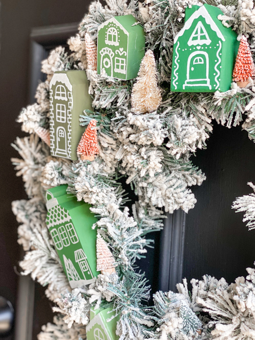 Create a festive DIY Christmas village wreath with thrifted items! This budget-friendly project adds a charming, personalized touch to your holiday decor.