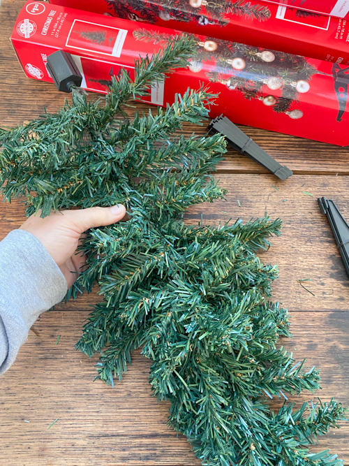 How to make DIY Dollar Store Christmas Swags for only $2.50 using supplies like 18" trees, floral wire, and ribbon. Perfect for budget-friendly holiday decor!