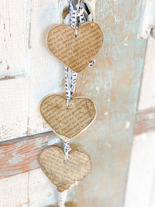 Create a charming DIY Heart Garland using air dry clay, book pages, and stain. This easy craft adds a vintage touch to your home decor for any season.