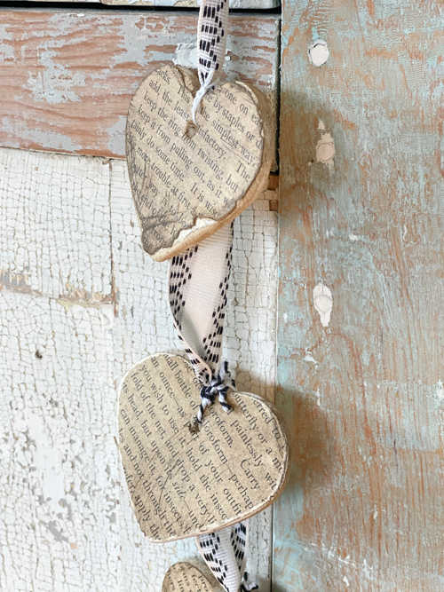 Create a charming DIY Heart Garland using air dry clay, book pages, and stain. This easy craft adds a vintage touch to your home decor for any season.