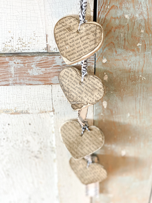 Create a charming DIY Heart Garland using air dry clay, book pages, and stain. This easy craft adds a vintage touch to your home decor for any season.