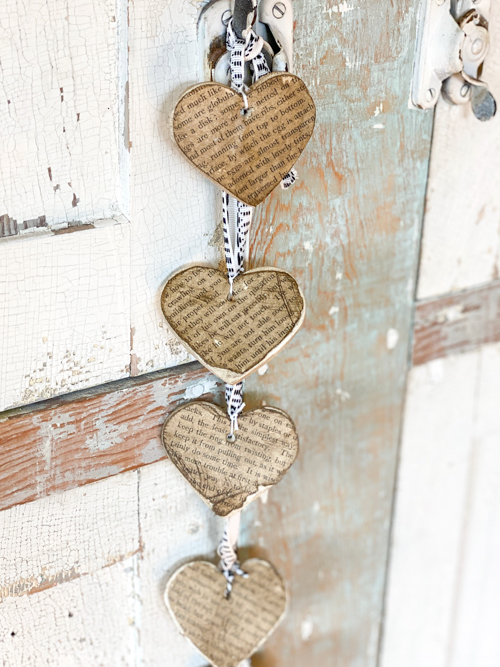 Create a charming DIY Heart Garland using air dry clay, book pages, and stain. This easy craft adds a vintage touch to your home decor for any season.