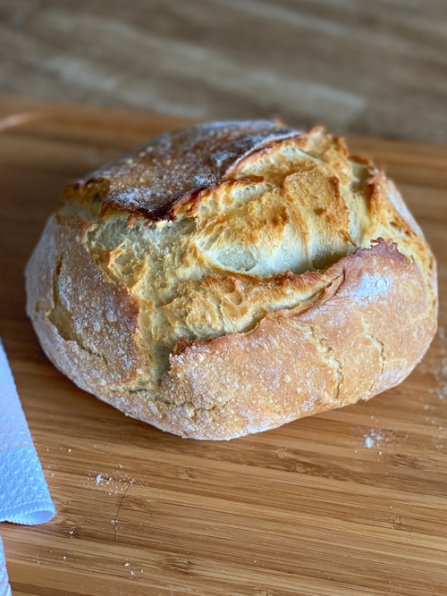 Learn how to make this Dutch Oven Bread Recipe with just 4 ingredients! A simple, delicious bread baked to perfection with a crispy crust and soft interior.