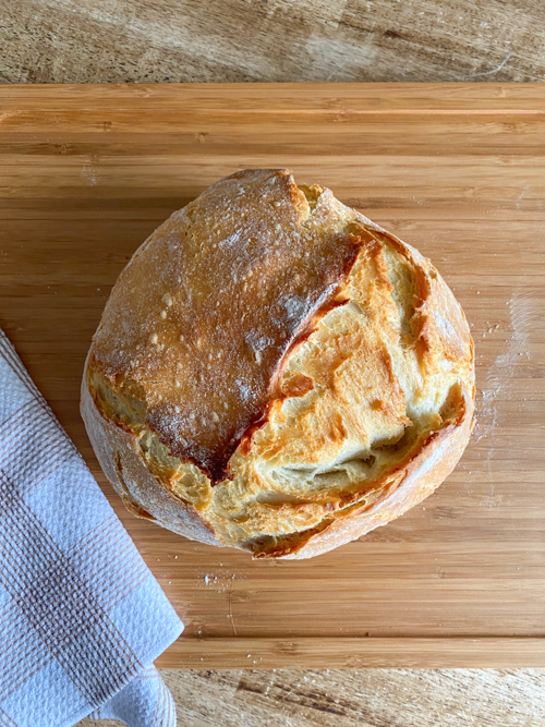 Learn how to make this Dutch Oven Bread Recipe with just 4 ingredients! A simple, delicious bread baked to perfection with a crispy crust and soft interior.