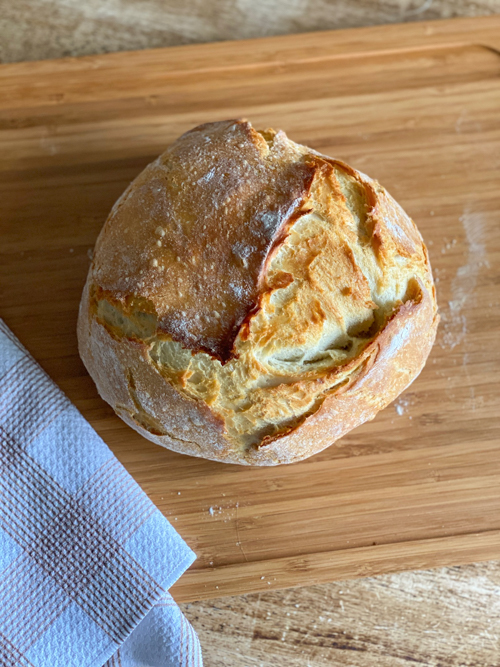 Learn how to make this Dutch Oven Bread Recipe with just 4 ingredients! A simple, delicious bread baked to perfection with a crispy crust and soft interior.