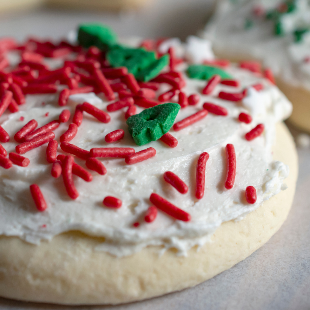 Soft, chewy sugar cookies made with sour cream for the perfect texture! This easy recipe makes a big batch, perfect for any occasion. Frost and enjoy!